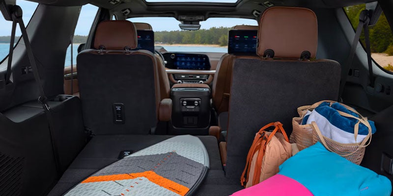 Spacious SUV cargo area with folded rear seats, showcasing luggage space for sports gear, bags
