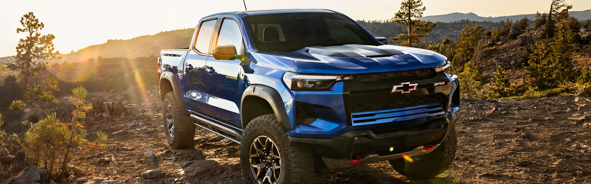 2026 Chevrolet Colorado parked next to a lake in the sand