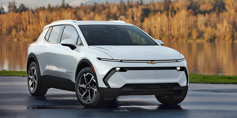 White Chevrolet Equinox EV parked on a wet road