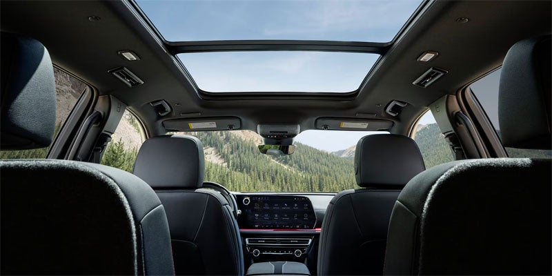 Spacious Chevrolet SUV interior featuring a panoramic sunroof, rear seating, and fold-flat cargo versatility