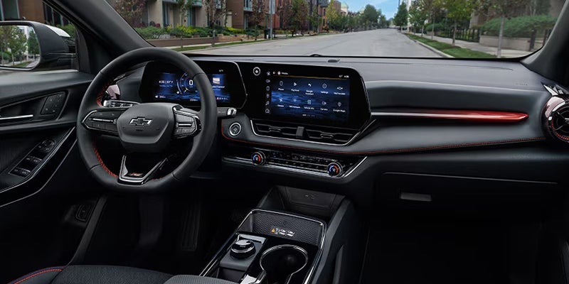 2027 Chevrolet Equinox EV front seats and open panoramic roof looking up at blue sky