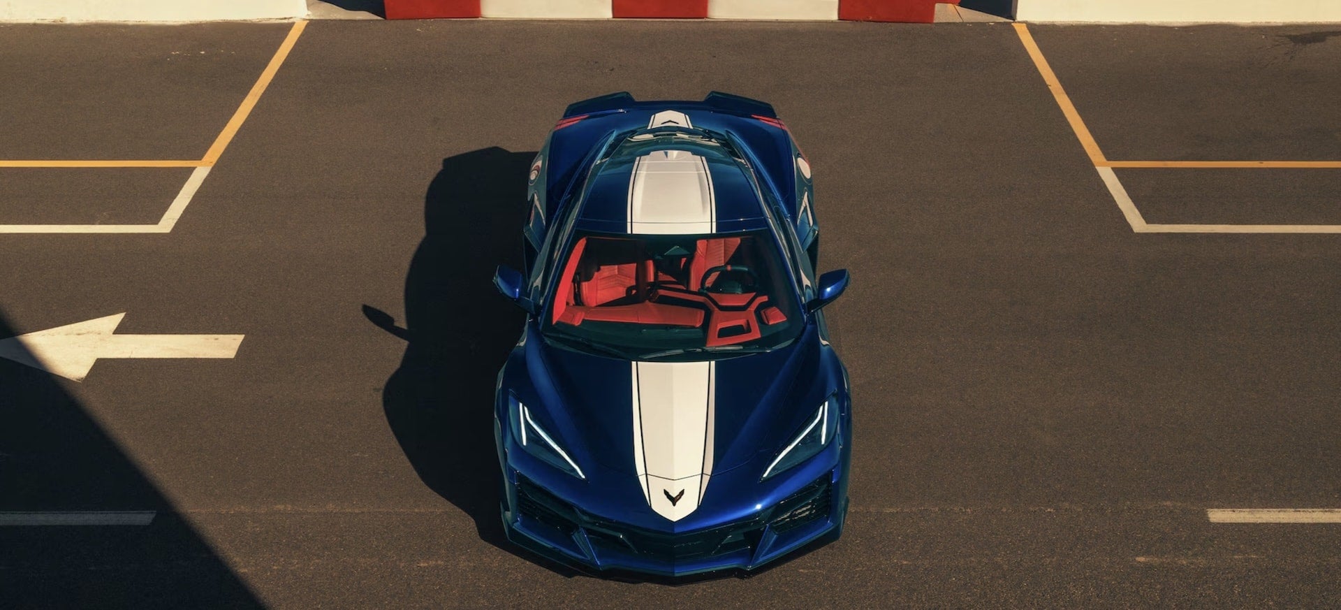 2027 Chevrolet Corvette Grand Sport in blue, overhead front view with white racing stripes