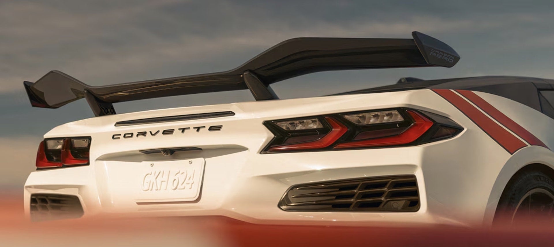 2027 Chevrolet Corvette Grand Sport rear close-up with carbon aero wing and red racing stripes