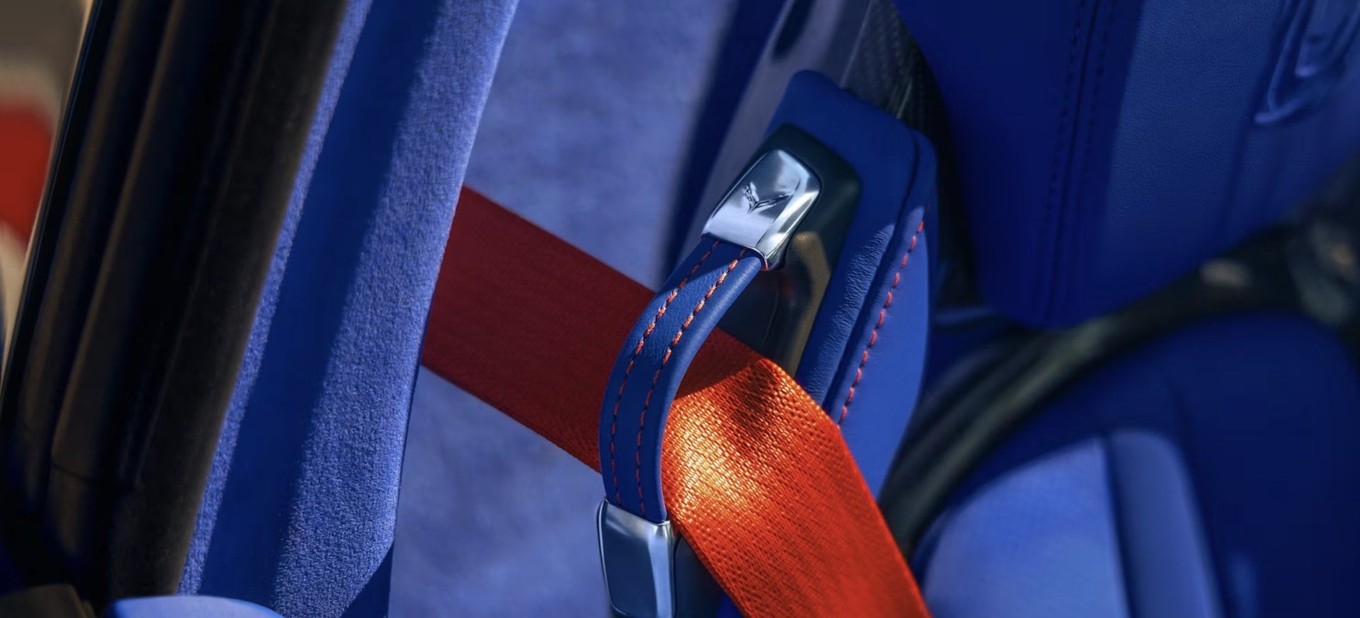 2027 Chevrolet Corvette Grand Sport seatbelt buckle close-up with Corvette logo and red belt