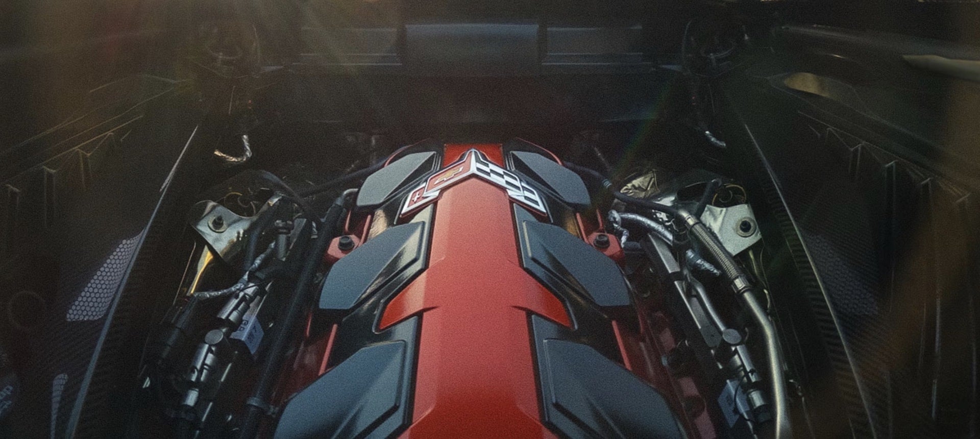 2027 Chevrolet Corvette Grand Sport engine bay with red cover and Corvette logo