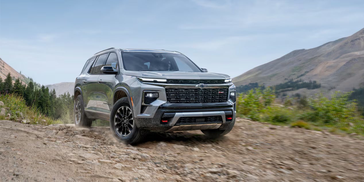 2026 Chevrolet Traverse driving on a dirt path out in nature